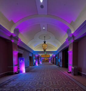 Creative AV utilizing LED wayfinding signs adding company branded colors to curate the atmosphere. 